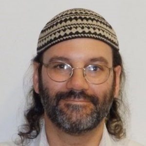 Headshot of a man with a beard and mustache wearing a cap