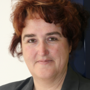 headshot of smiling woman with short red hair