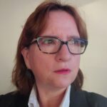 Headshot of woman with glasses and brown hair