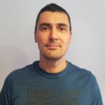 Headshot photo of man with short dark hair